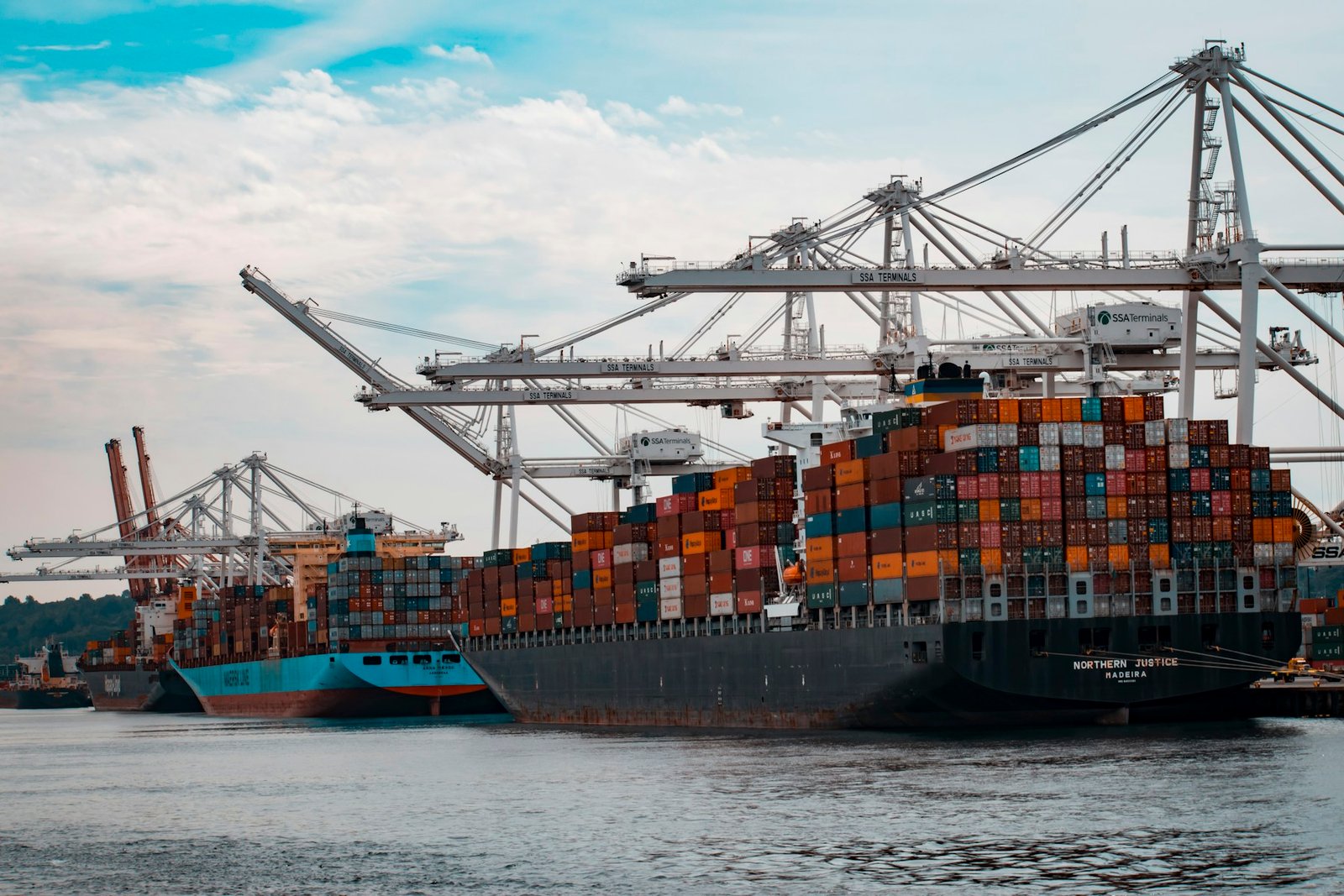 Container ship alongside terminal cranes