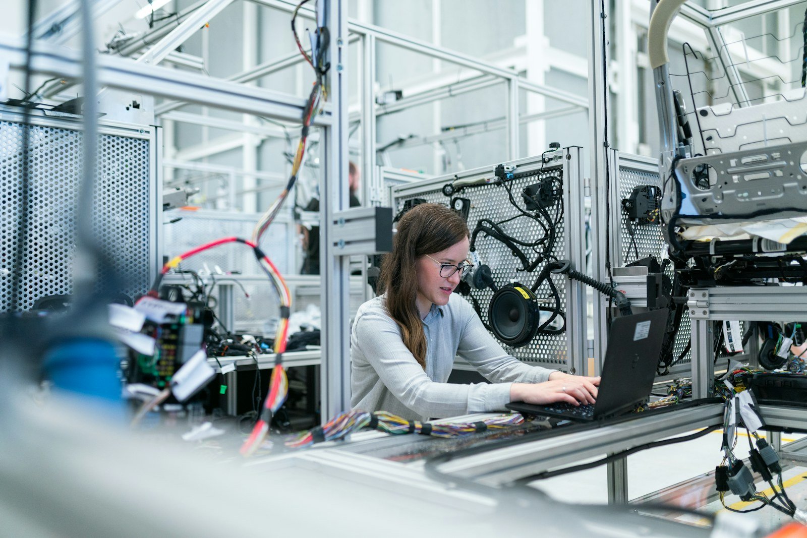 Engineer working with a laptop on a production line