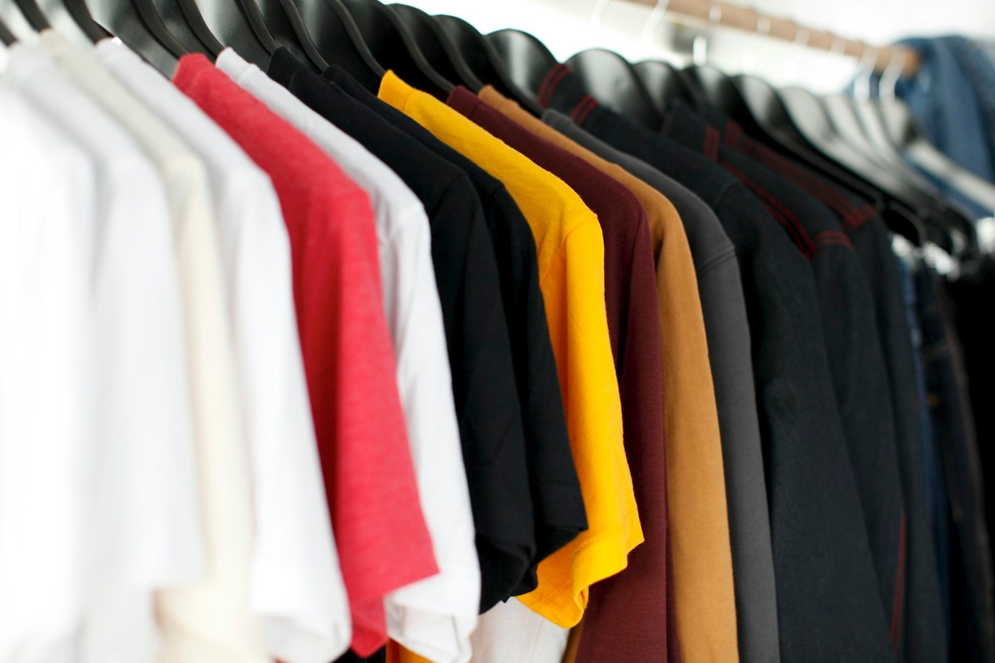 Mixed shirts in several colours on a rack